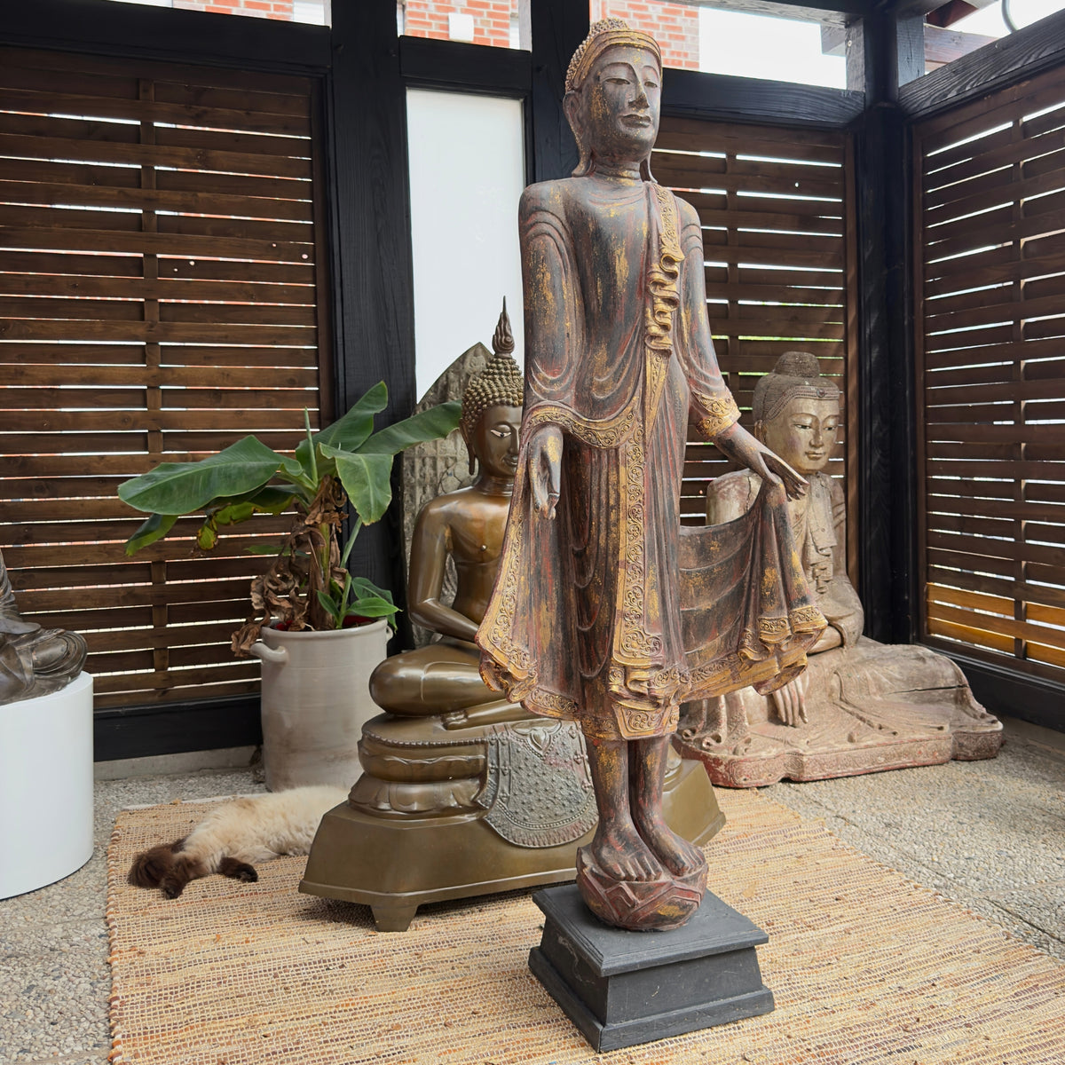 Monumental antique Burmese standing Buddha made of teak wood with original gilding and lacquer.