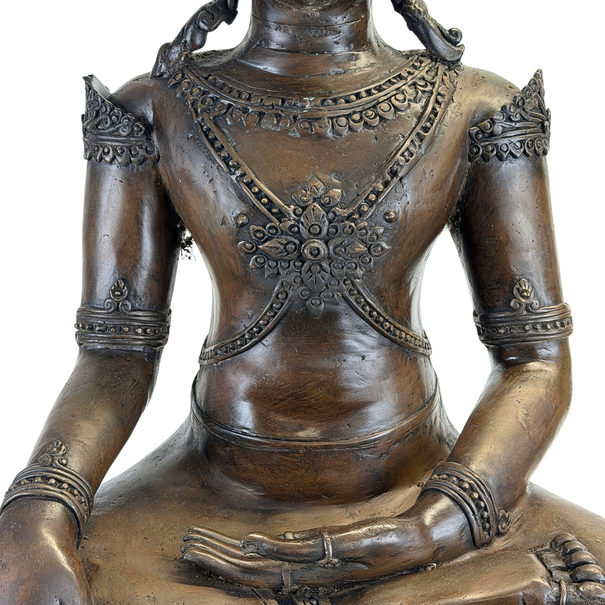 Detail of chest ornament and jewellery on the antique Thai crowned Buddha