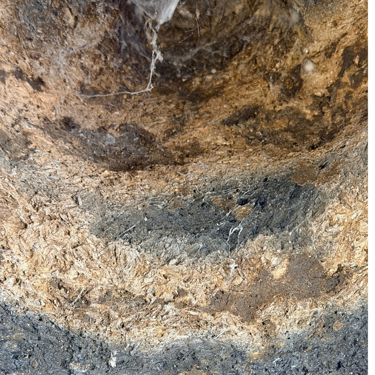 Macro detail of old casting core and deposits inside the antique Thai bronze Buddha