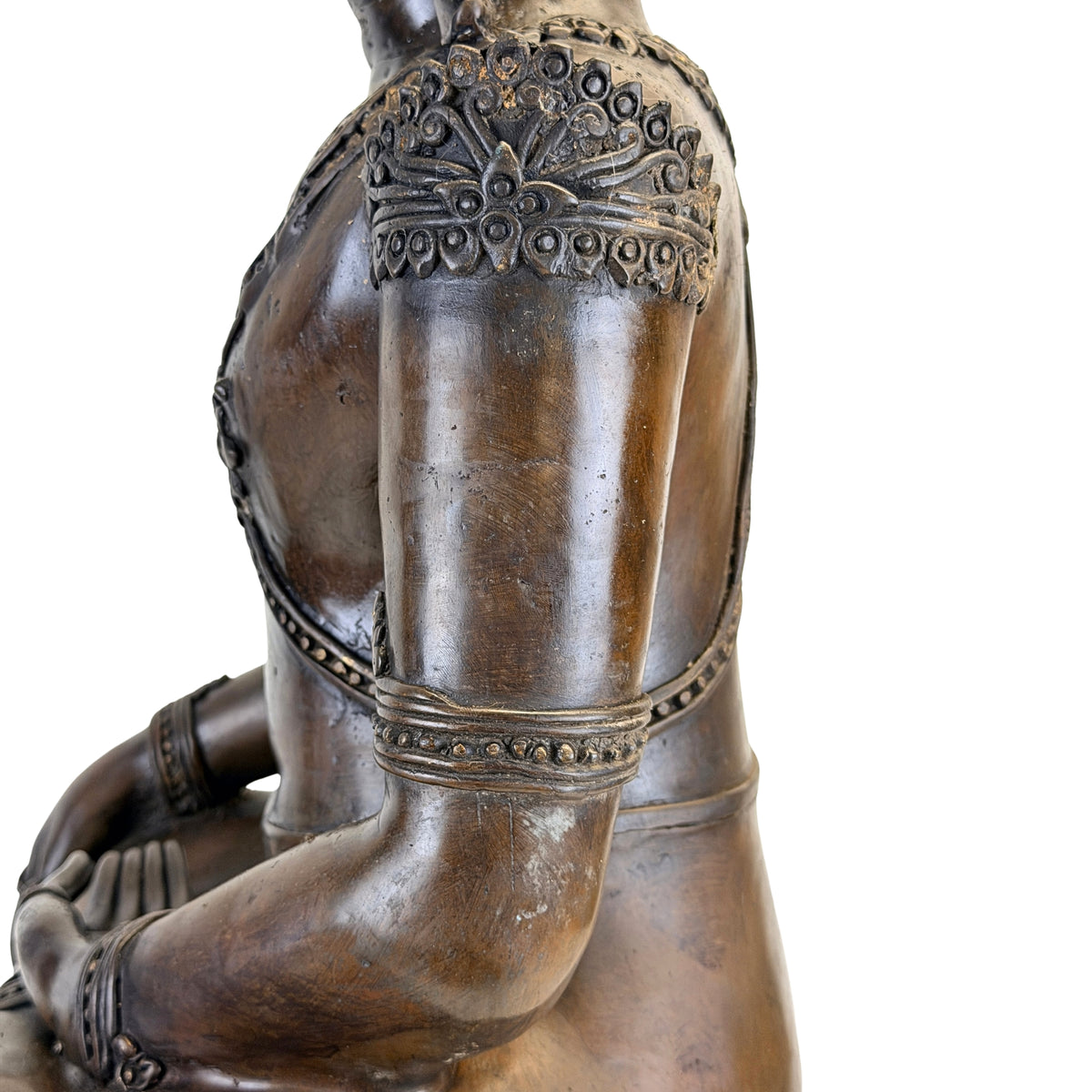 Detail of left arm, shoulder and back of the antique Thai bronze Buddha