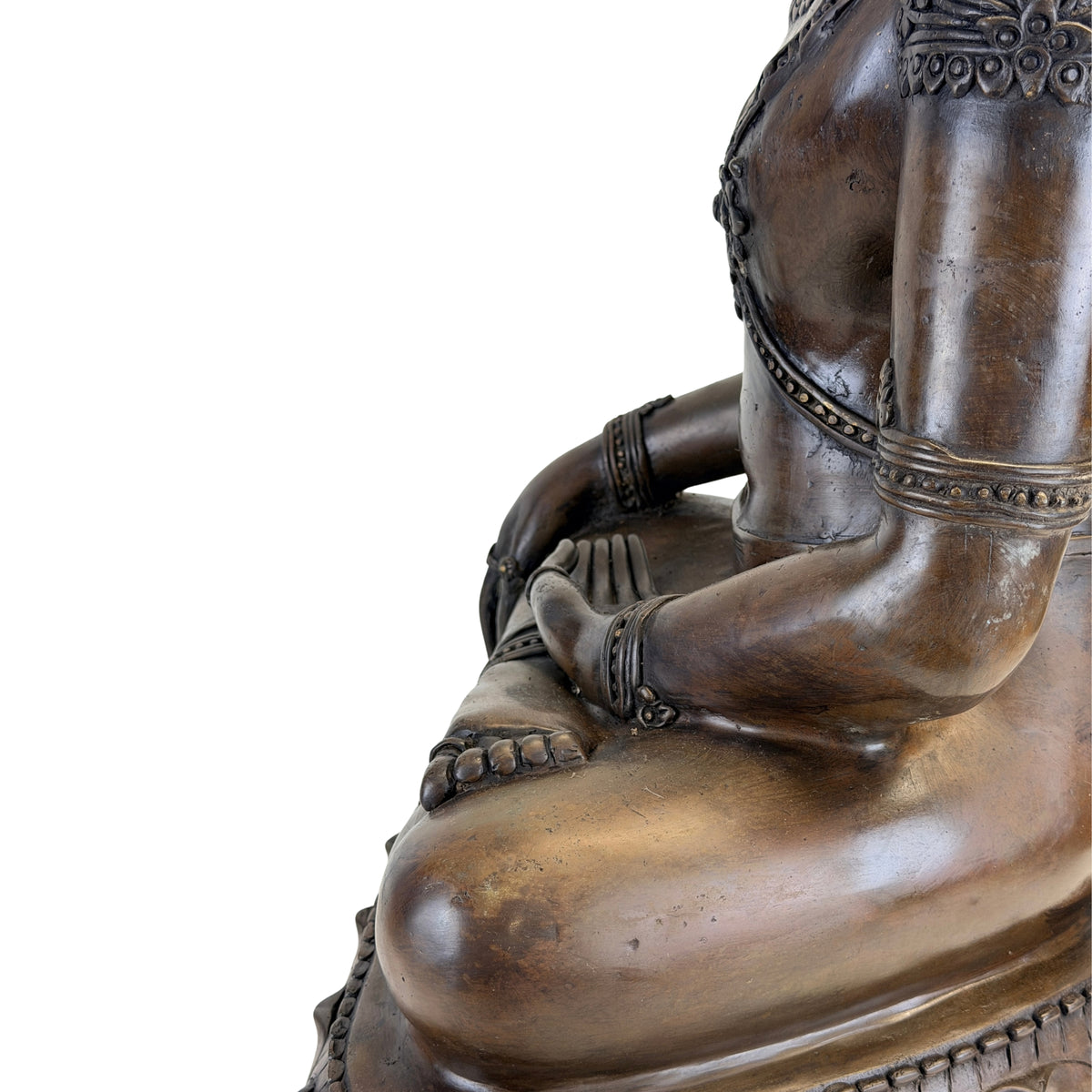 Side view of the left arm and seated posture of the antique Thai Buddha