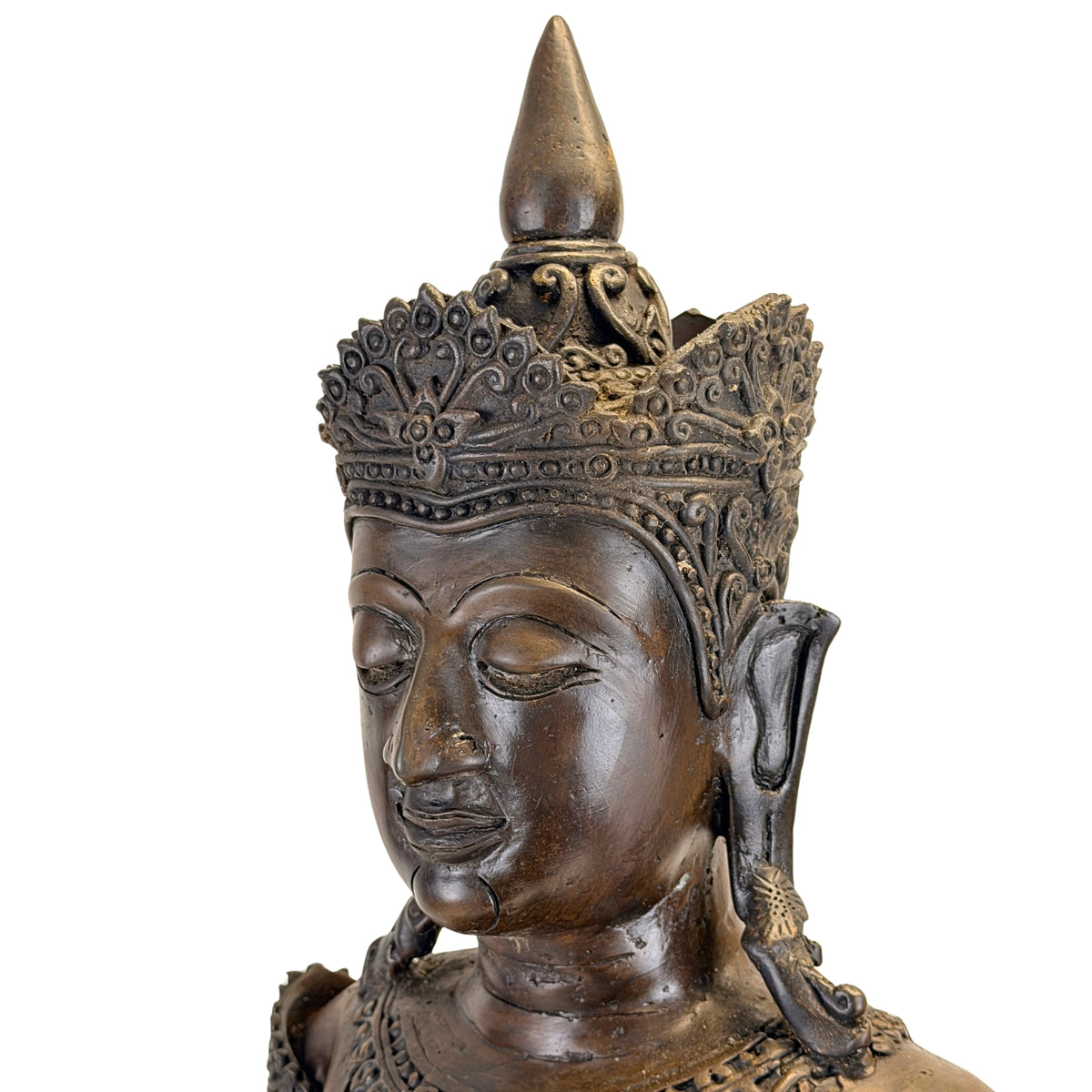 Three-quarter portrait of the antique Thai crowned Buddha