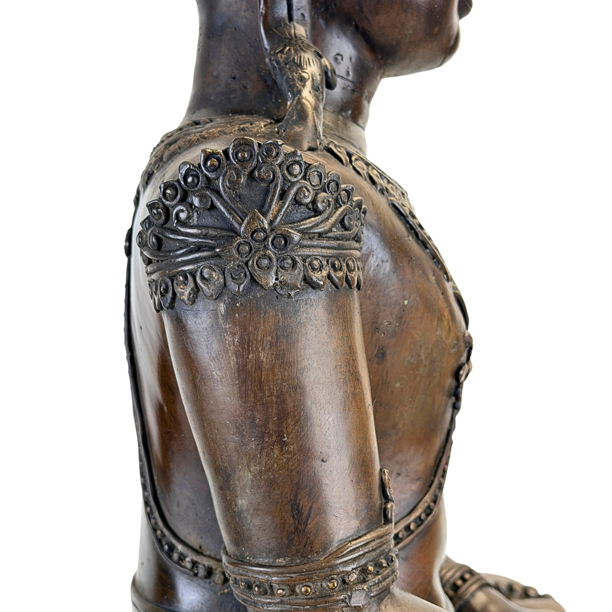 Side view of shoulder ornament and upper arm on the antique Thai bronze Buddha