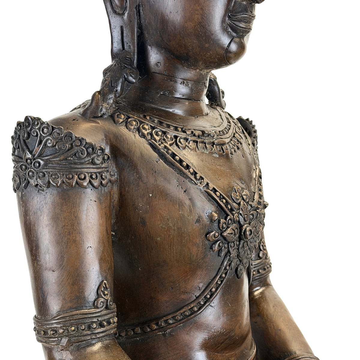Detail of shoulder ornament and chest necklace on the antique Thai Buddha