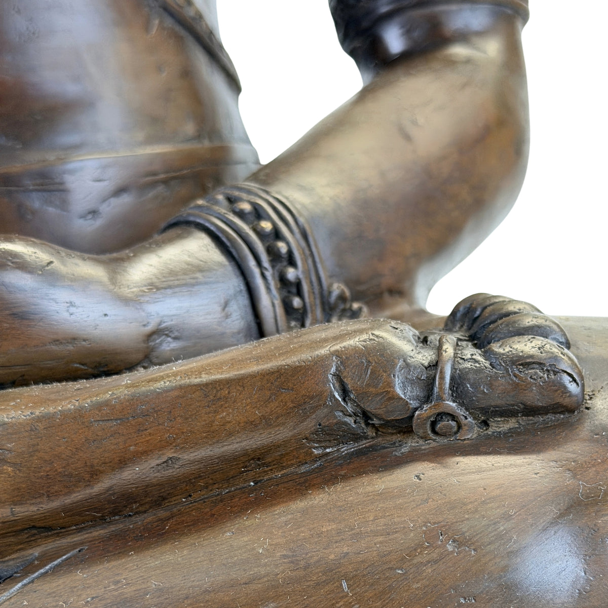 Detail of foot and ankle ornament on the antique Thai bronze Buddha