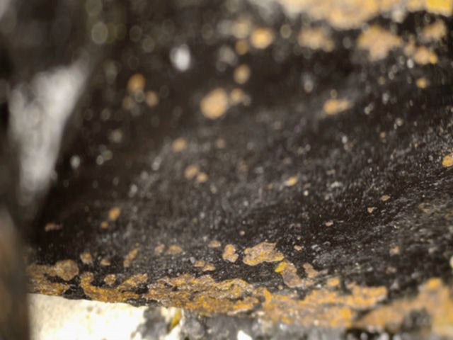 Macro view of the dark interior and old surface deposits