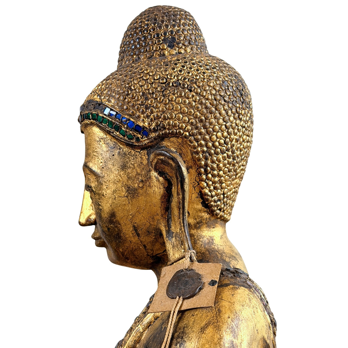 Seitenprofil des Buddha-Kopfes mit Haarlocken und Glaseinlagen