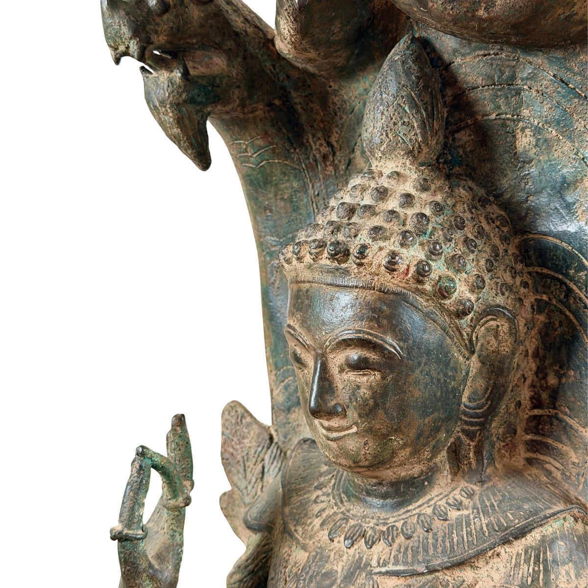 Detail of the Buddha face with hair curls and naga head above
