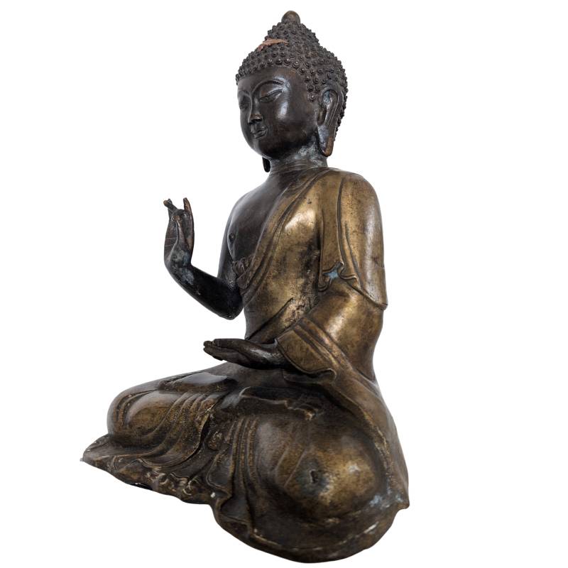 Gesicht einer chinesischen Buddha-Statue aus Bronze mit sanftem Ausdruck