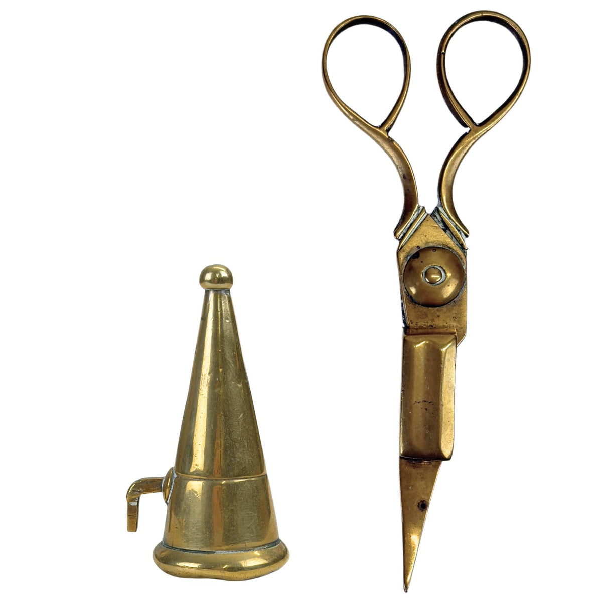 Close-up of the antique brass extinguishing cone next to the matching candle scissors, both in authentic style.