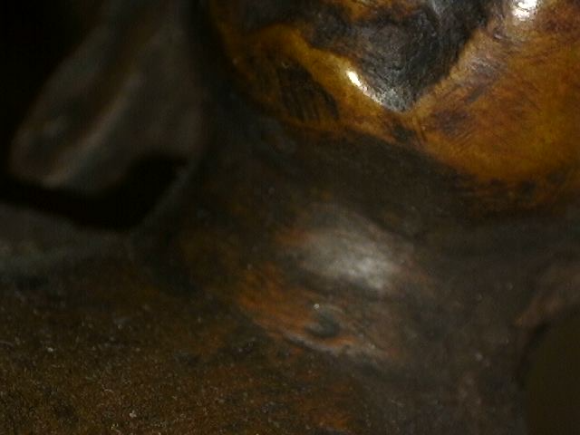 Mikroskopische Detailaufnahme der Handbearbeitung einer Buddha-Statue aus Bronze mit Meditationsmudra