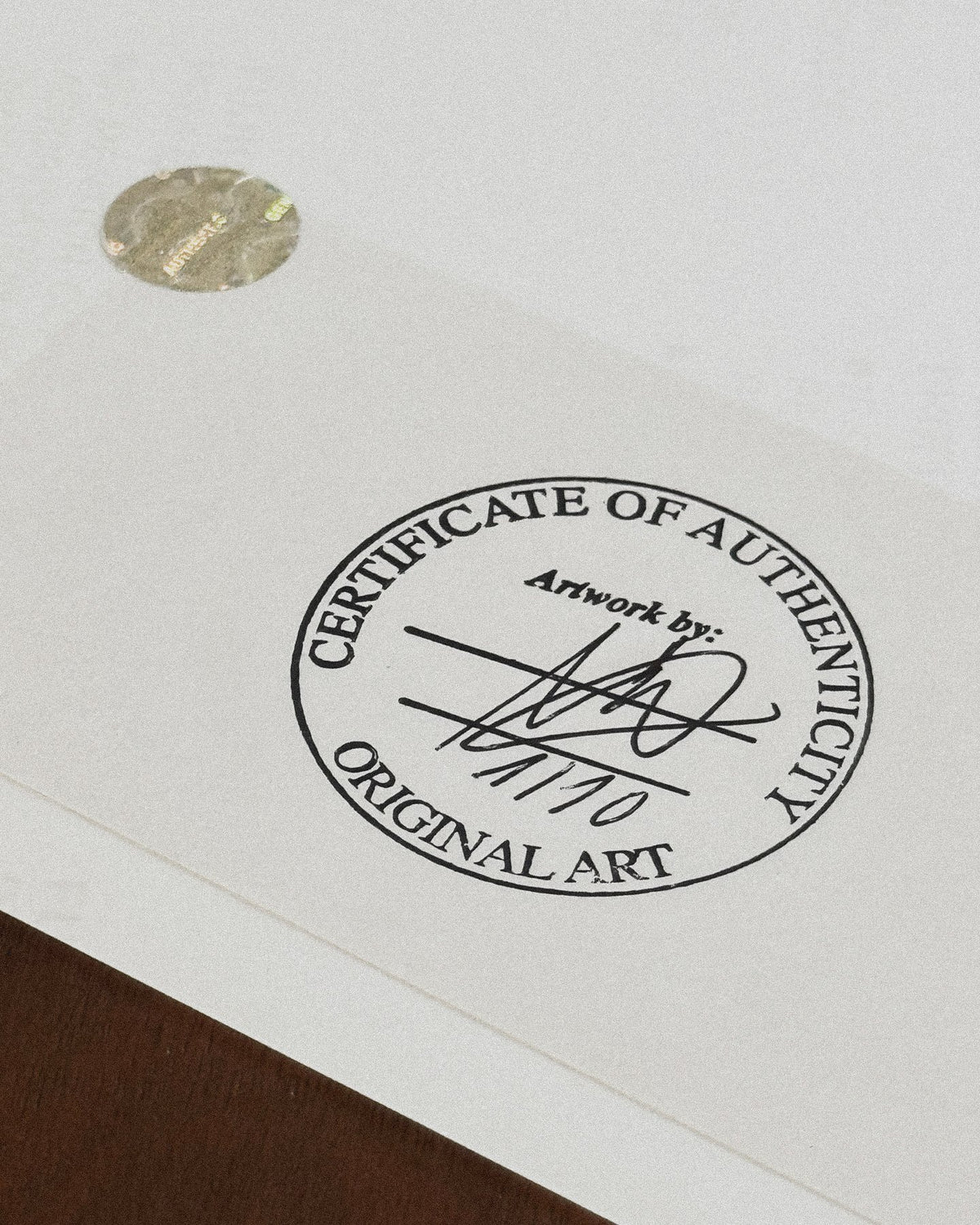 Close-up of the official Certificate of Authenticity stamp and the handwritten edition numbering 2/10 on the back of the geisha artwork.