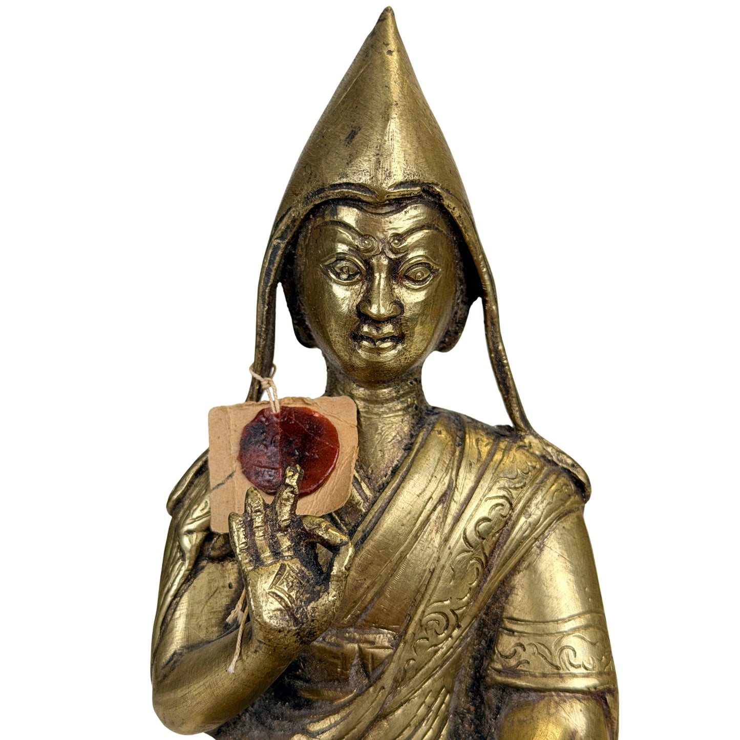 Gesichtsdetail der tibetischen Lamafigur neben dem roten Exportetikett von 1962